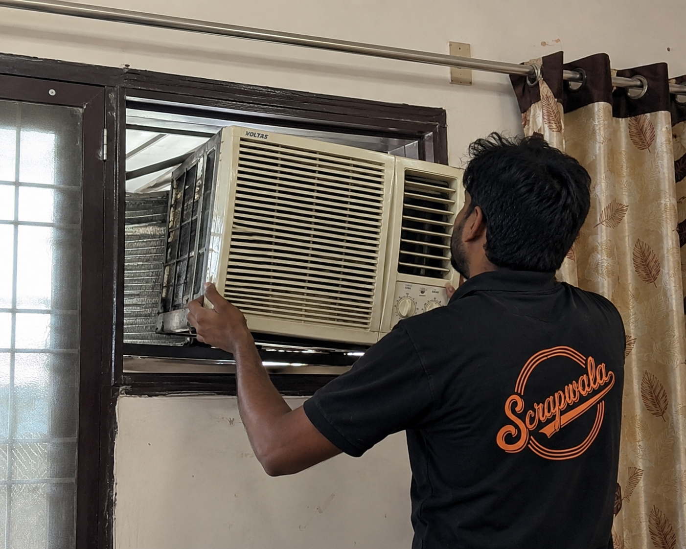 Old window AC unit being removed